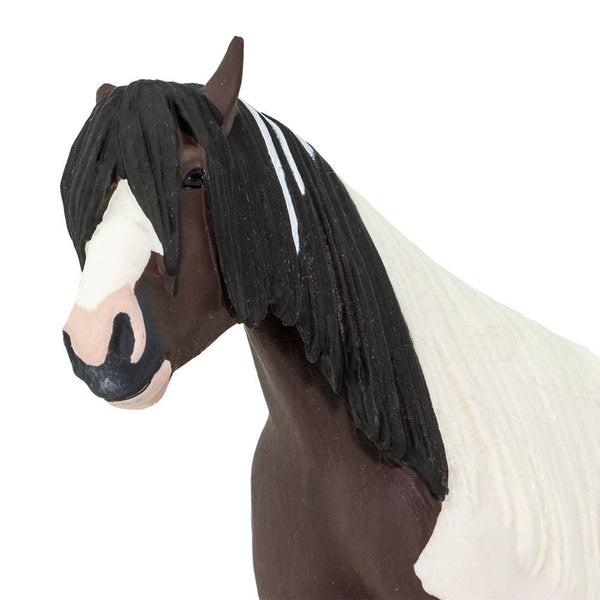 Brown and cream horse with a flowy tail and  mane