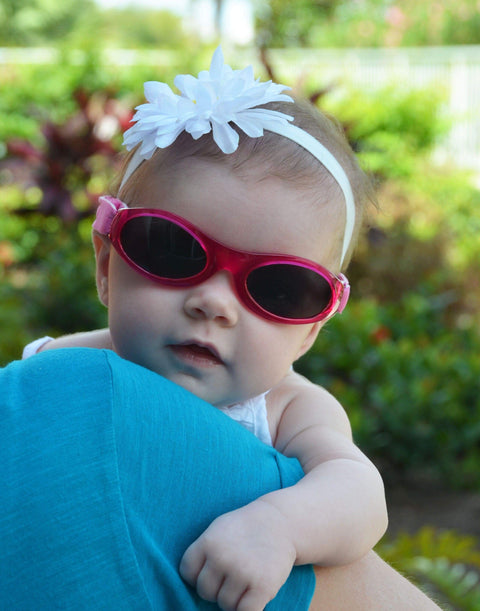 Baby wearing pink sunglasses