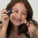 Girl playing with skunk and weasel