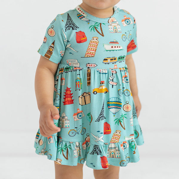 Girl wearing a dress Aqua canvas with iconic structures and transportation from all around the world