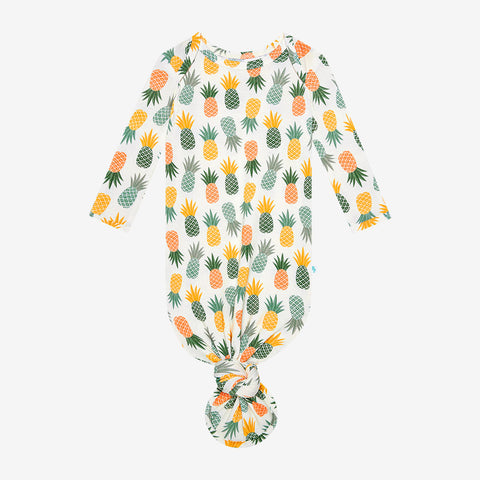 Pineapple print.  Light Green, Dark green, Orange, and Yellow Pineapples are repeated all over gown.