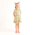 Girl wearing Short sleeve twirl has a scoop neckline. The print has a white background with horizontal stripes in aqua, sage green, mustard, and coral