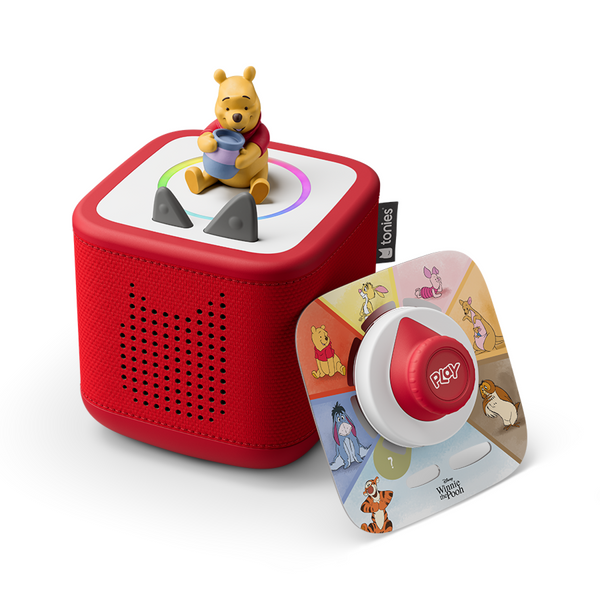 Red toy with a bear figure on top, featuring Tomy branding, on a white background.