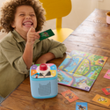 Child playing with a toy and cards on a wooden table