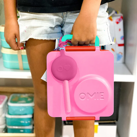 Child holding omie lunch box with Pod