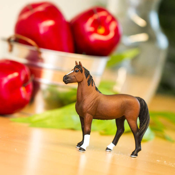 This Morgan Stallion figure is 4 ¾ inches long and 4 ¼ inches tall to the top of its ears. It's about the size of a standard 11-ounce ceramic mug. This horse features a chestnut brown coat with a black nose, mane and tail. He's got two black socks and two white socks, and his hooves are black with silver shoes