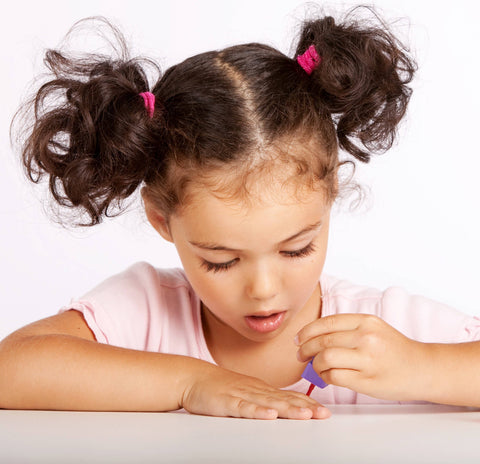 Little girl painting her nails
