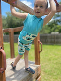 Child in sleeveless hoodie and shorts with camper on them