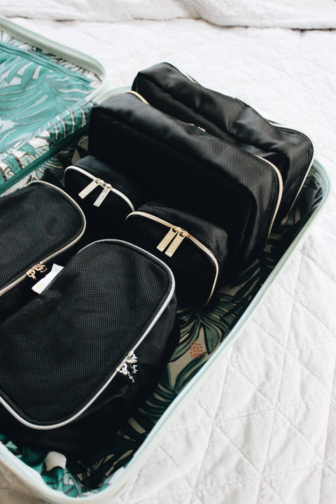 Itzy Ritzy - Black & Silver Pack Like a Boss™ Packing Cubes in suitcase