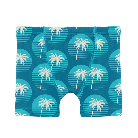 Deep blue with aqua sunset circles with white palm trees in them