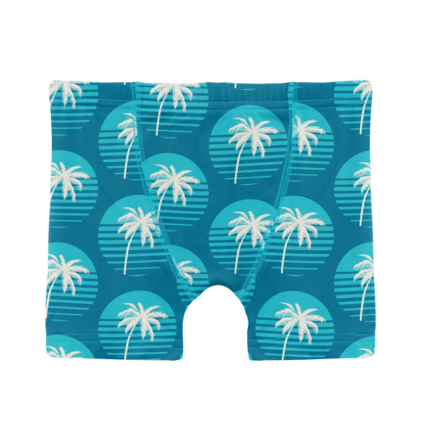 Deep blue with aqua sunset circles with white palm trees in them