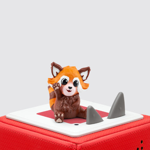 A tan and brown red panda sitting and waving on top of a Red Toniebox.