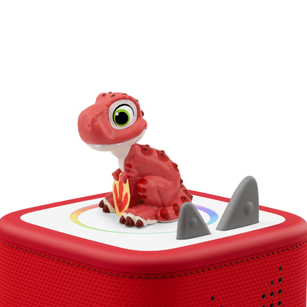 A red robotic dinosaur toy sitting on a red square speaker base with gray shark teeth and a white top panel, photographed on a clean white background.