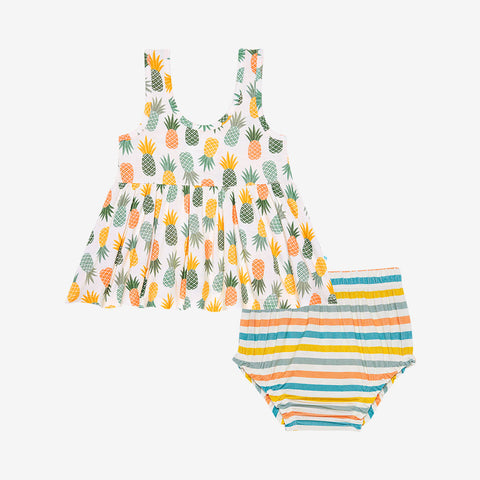 Peplum top is sleeveless and has Pineapple print.  Light Green, Dark green, Orange, and Yellow Pineapples are repeated all over gown. It comes with a pair of Bummies bottoms that have coordinating colors in stripes.
