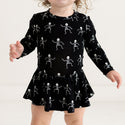 Black long sleeve twirl bodysuit with white dancing skulls that glow in the dark.