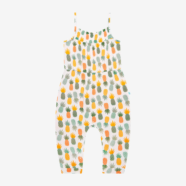 Jumpsuit has a white background with Light Green, Dark Green, Yellow, and Orange Pineapples all over it.