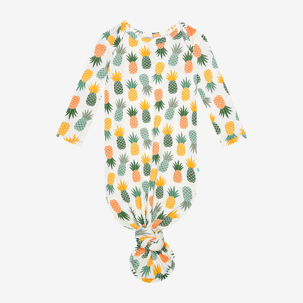 Pineapple print.  Light Green, Dark green, Orange, and Yellow Pineapples are repeated all over gown.