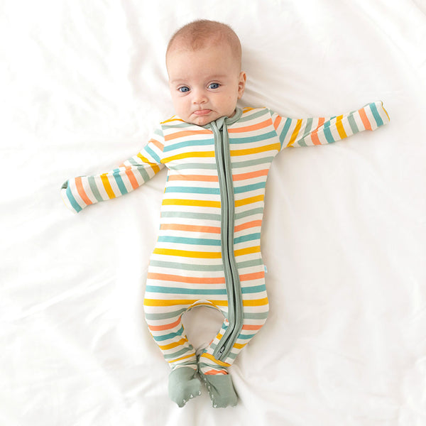 Baby wearing the One Piece. The cuffs of the sleeves are folded in acting as mittens. The cuffs of the legs are also folded over feet to provide warmth. This is the white background with horizontal stripes. Aqua, Mustard, Sage Green, and Coral