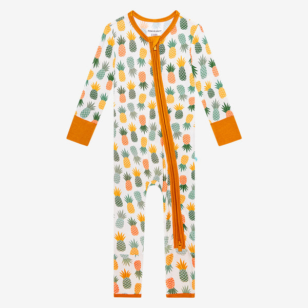 Long Sleeve, long length pants Zippered One Piece. This Print has Pineapple print.  Light Green, Dark green, Orange, and Yellow Pineapples are repeated all over gown. With Bright Orange Trim following the Zipper Path, neckline, cuffs of sleeves and bottom cuff of pants