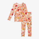Long sleeved two piece pajama. Print is red, white and yellow flowers on a peach background.