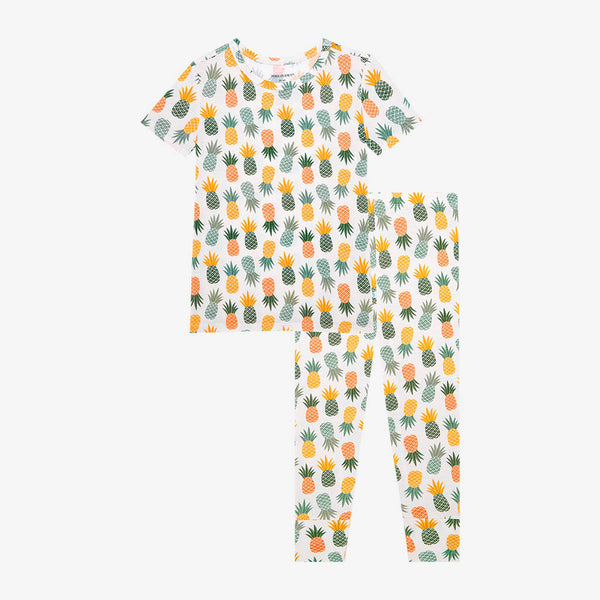 Short Sleeve shirt with Long Pants. Both are the Pineapple print. Light Green, Dark green, Orange, and Yellow Pineapples are repeated all over.