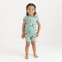 Girl wearing Two piece PJ set in aqua with iconic structures, buildings and modes of transportation all over
