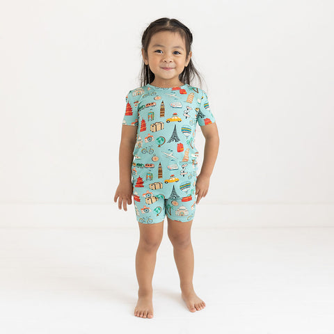 Girl wearing Two piece PJ set in aqua with iconic structures, buildings and modes of transportation all over