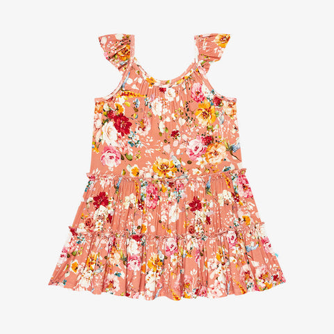 Tiered flutter sleeve dress. Print is orange, red, yellow and white floral on a peachy background.