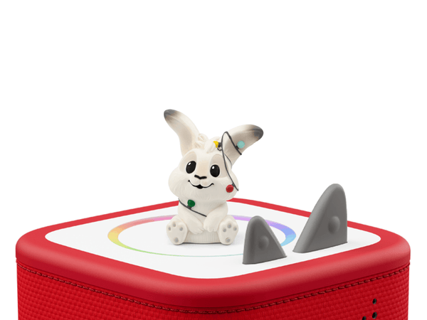 White rabbit figurine on a red toy box  on a white background