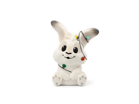White rabbit figurine with a black hat on a white background