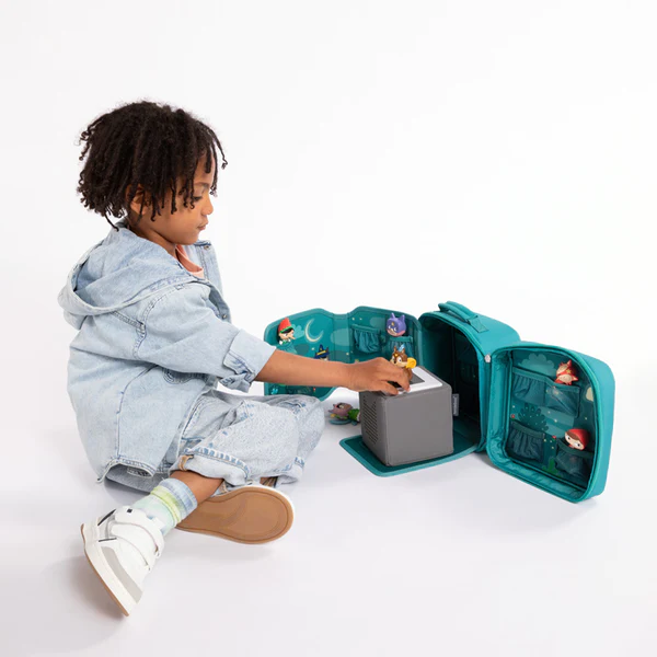 Child playing with grey tonie box inside the carrying case