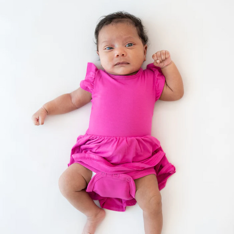 Baby wearing Twirl bodysuit dress in Raspberry