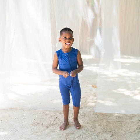 Boy wearing the sleeveless romper in A deep cobalt blue