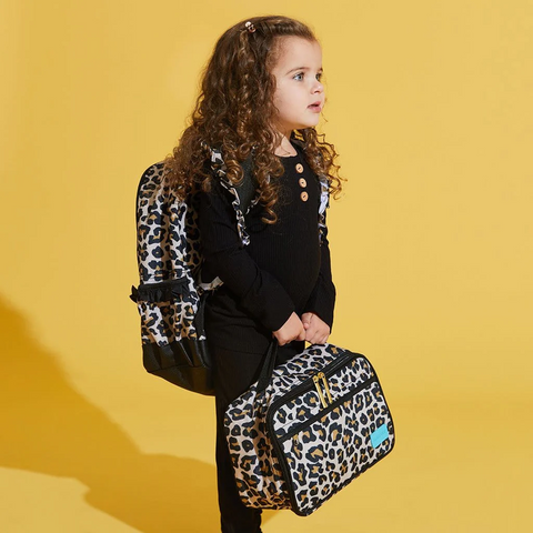 Girl holding Lunch bag with tan leopard print. Black trim and gold hardware