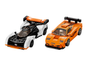 2 Mclaren race cars. One is Orange and one is white