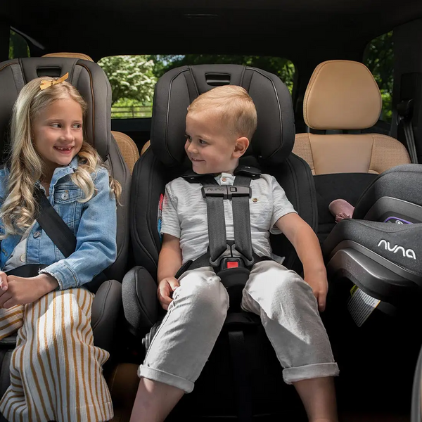 Car seat with children buckled in. 