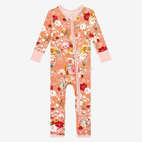 One Piece PJ. Print is orange, red, yellow and white floral on a peachy background.