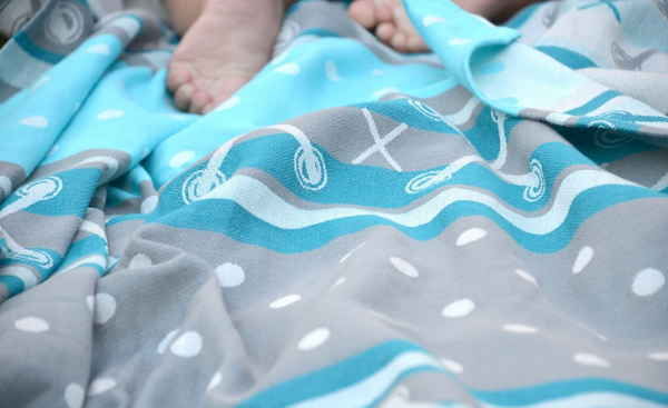 Cotton Baby wrap in aqua, blue, gray, and white.