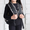 Girl wearing Leopard print back pack with solid black front pocket and ruffle seams