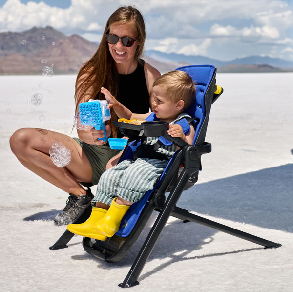 woman and child with the switchback seat clicked into the veer highchair frame