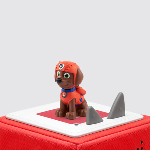 Tonies Paw Patrol Zuma character is a brown dog with a red suit sitting on a red TOniebox.
