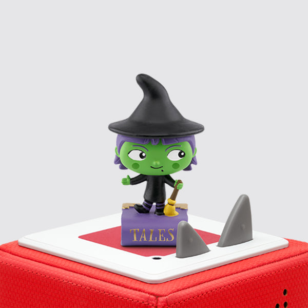 Green witch Tonie with a black hat and a broom on a red Toniebox.