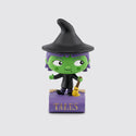 Green witch Tonie with a black hat and a broom on a purple book.