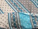 Cotton Baby wrap in aqua, blue, gray, and white.