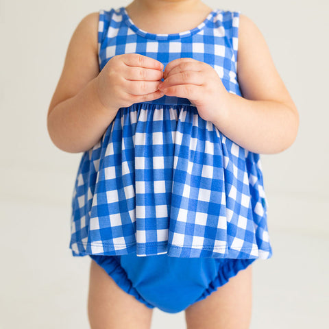 Toddler standing in a Blue and white checked bloomer set