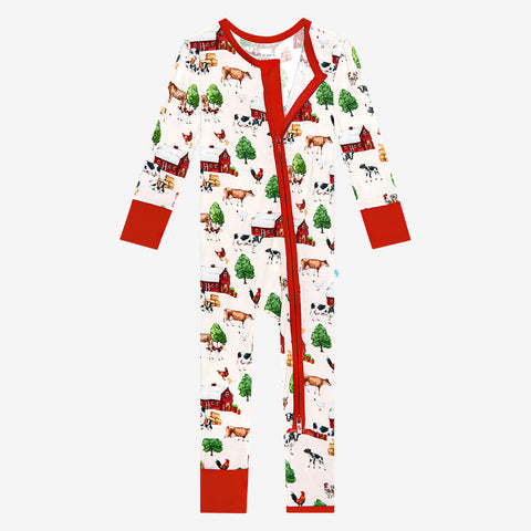 Convertible one piece with zipper. Country farm print on a cream background. Zipper, wrists and foot cuffs are red.