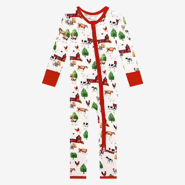 One piece zippered one piece. Country farm print on a cream background. Zipper, wrists and foot cuffs are red.
