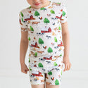 Boy standing in pajama set. Country farm print on a cream background.