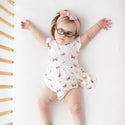 LIttle girl in bodysuit with twirl skirt. White solid background with butteflies print