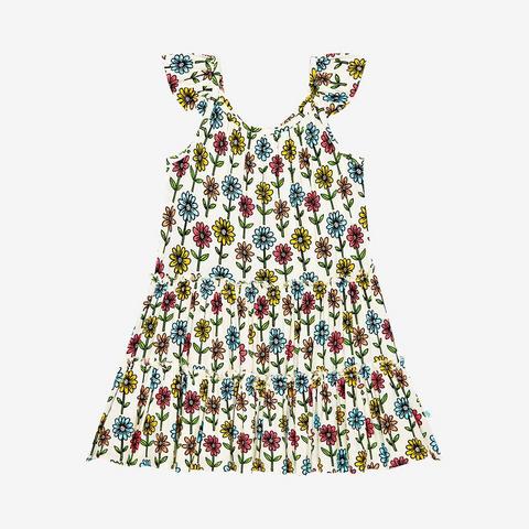 3 Tiered Dress with Flutter Sleeves. The dress Print is a floral on a cream background. The Flowers are single daisies on stems and vary in color. Light Blue, Yellow, light orange, and pink.